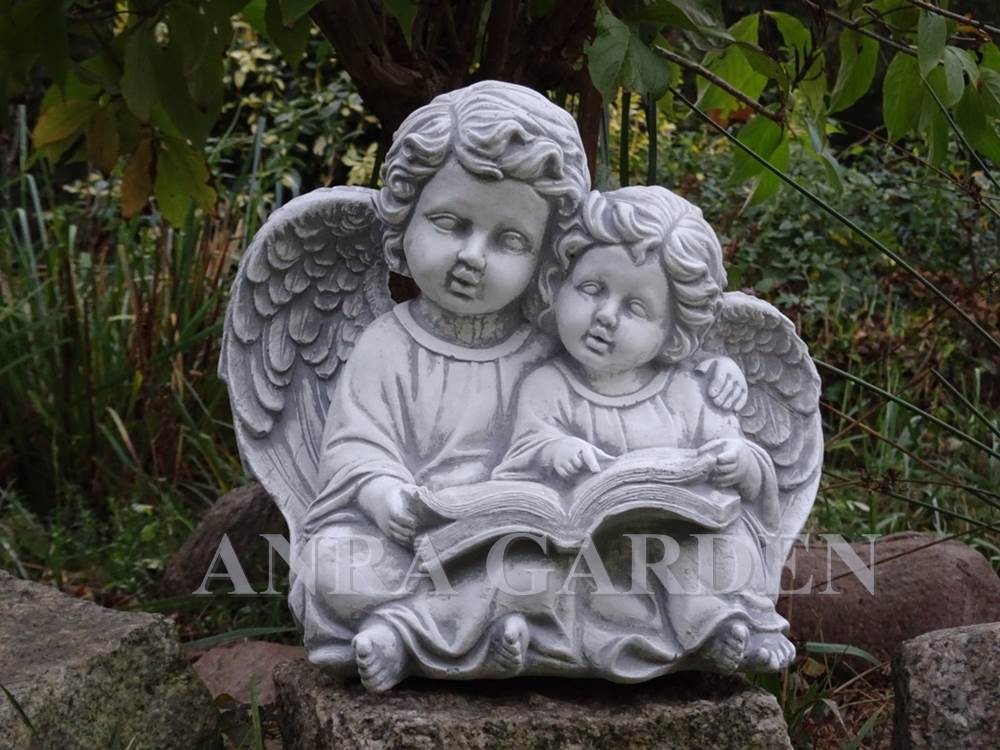 A figure of two angels with a book